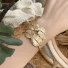 A golden feather-shaped bracelet is a fashionable and light luxury wrist accessory for ladies details Picture